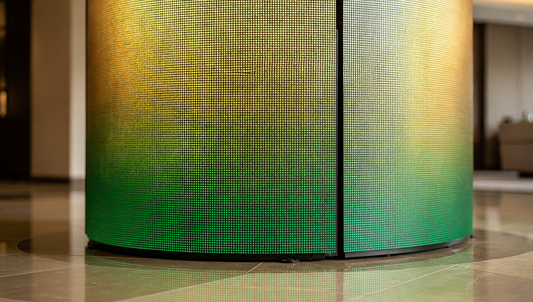 Curved LED display feature wrapping a lobby column in a commercial building